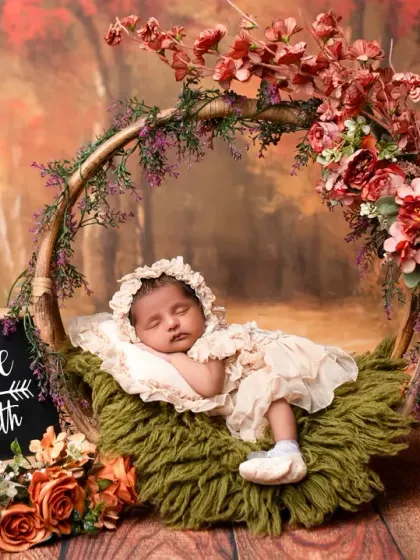 Celebrating one month with an autumn-themed newborn shoot. The warm colors and rustic props create a cozy and beautiful setting for this milestone.