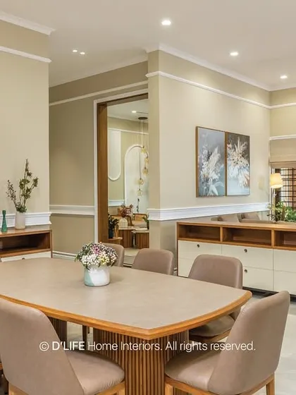 This spacious dining and living area is designed with a neutral palette and clean lines. Low-slung sideboards provide ample storage while maintaining a minimalist aesthetic.