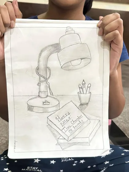A still life sketch of a study desk, complete with a Harry Potter book. We love drawing things that are personal to us.