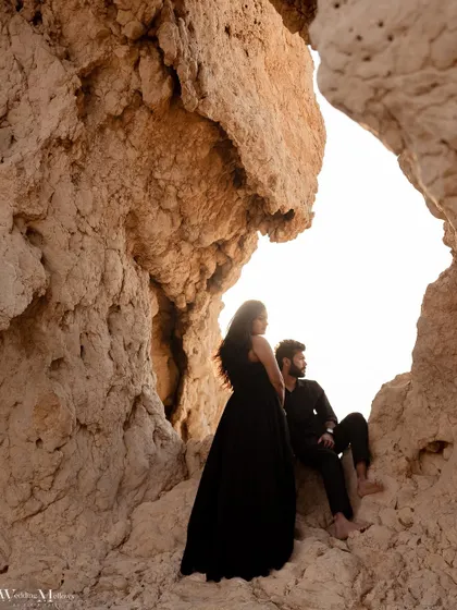 A creative shot looking out from a desert cave. This framing adds depth and a sense of discovery to this intimate portrait.