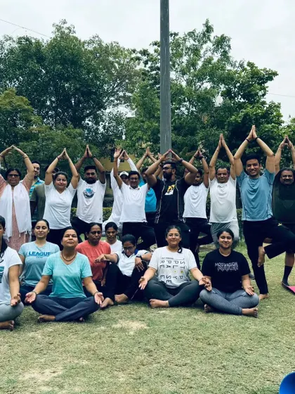 A group of participants in a combination of seated and standing poses, creating a beautiful tree-like formation. This represents growth and balance.