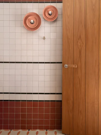 Another detail of the bathroom, showing the simple, clean lines of the teak door and the graphic tilework.