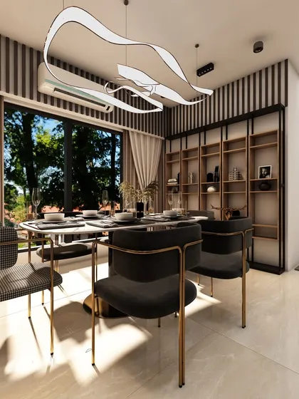The dining area in this space is defined by a unique, wave-like chandelier and a built-in bookshelf, blending functionality with artistic design.