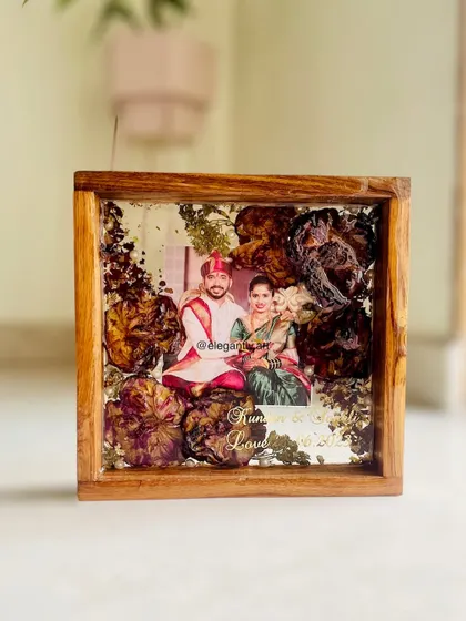 Another beautiful example of a wedding garland preserved in a teakwood frame. The design is custom-made to reflect the couple's style and story.
