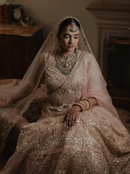 My bride, Sanskriti, in her breathtaking Manish Malhotra lehenga. This portrait, taken in a quiet moment at Rambagh Palace, captures her serene beauty and the luxury of the occasion.
