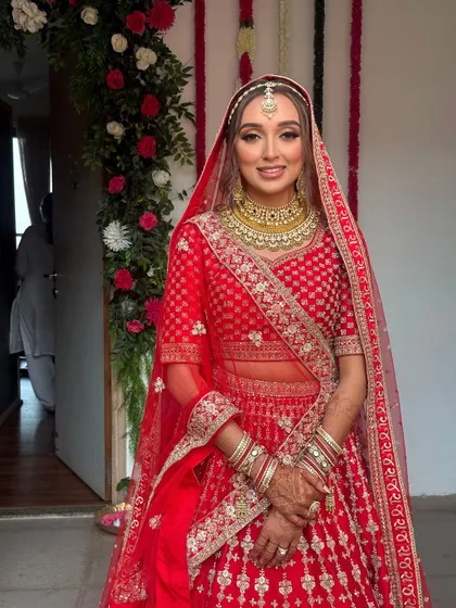 The bride is all smiles, ready for her big day. Her hair looks perfect, and the style will last throughout the ceremony and reception.