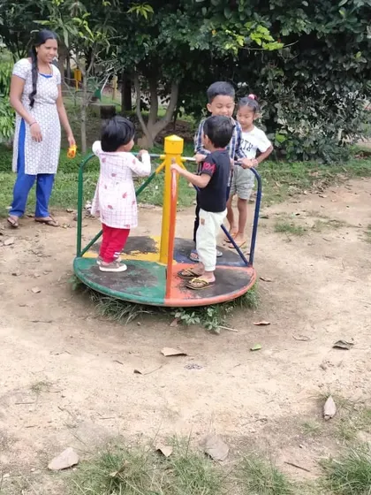 Playtime at the park on the merry-go-round. I supervise closely to ensure safety while allowing the children the freedom to play and interact with each other.