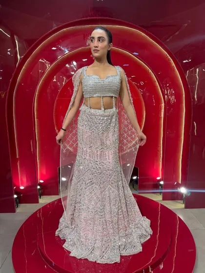 If there was an Indian Barbie dress, this would be it. A stunning silver and pink fish-cut lehenga with a delicate cape, perfect for a cocktail or reception.