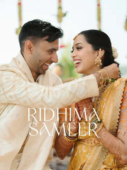 A joyful, candid portrait of the couple during their wedding ceremony, their laughter making the photo feel alive.