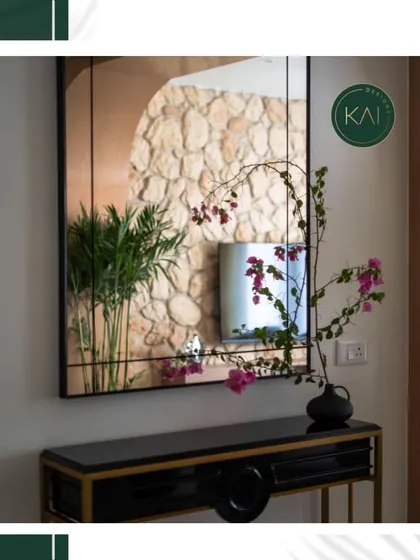 The black and gold console table shown in a styled entryway, reflecting a beautifully curated interior. This demonstrates how our furniture can complete and elevate a space.
