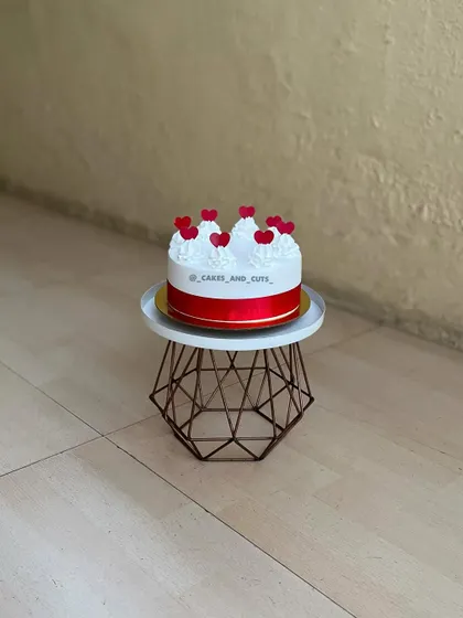 A simple and sweet cake with red hearts, perfect for expressing your love.