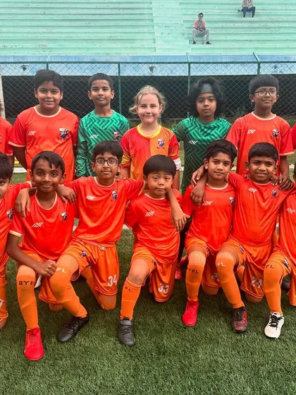 The victorious U11 team, soaked but smiling after their win in the rain.