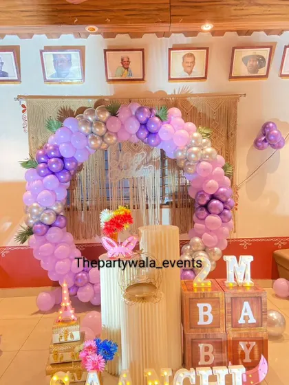 Another view of the 2-month birthday celebration with a purple and silver balloon ring.