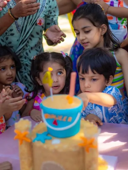The kids eagerly gathered around the sandcastle cake. These moments are so precious.