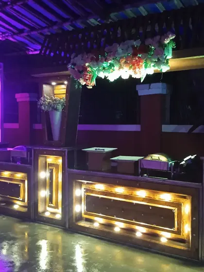 A wooden buffet counter with built-in lighting, perfect for creating a warm and inviting atmosphere at evening events.