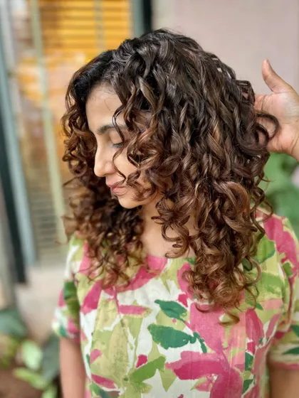 A happy client with her new chocolate swirl curls. The cut and color are a perfect match. (No filter)