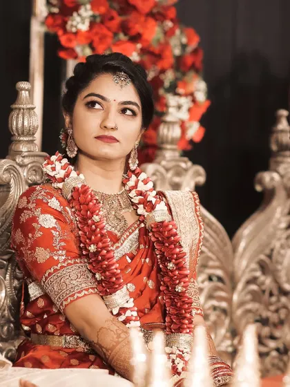 A thoughtful pose, capturing the bride's serene beauty and the intricate details of her bridal attire.