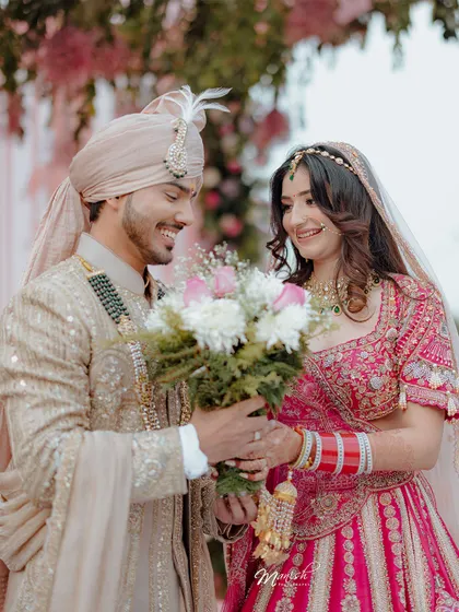 The groom presents his bride with a bouquet, a modern romantic gesture amidst the traditional wedding ceremony.