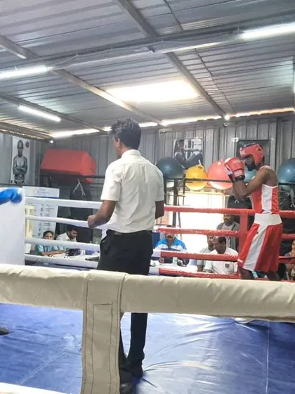 A live-action shot from the university boxing finals. My fighter is in red, executing the strategy we practiced.