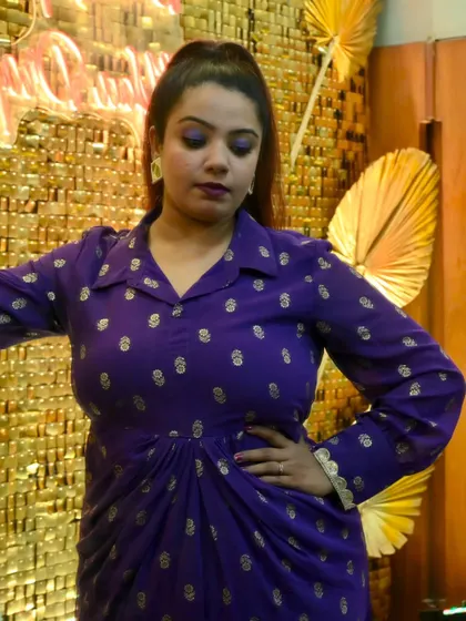 Another look at my purple Sangeet outfit against a shimmering gold backdrop. I believe an anchor's presence should add to the visual splendor of the event.