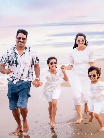 The best moments are unposed. Here, the whole family is running towards the camera, laughing with the waves at their feet. This candid family beach photo captures pure energy and happiness.