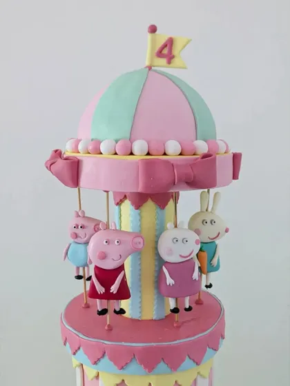 A close-up of the carousel top, featuring Peppa, Suzy Sheep, and Rebecca Rabbit enjoying the ride.