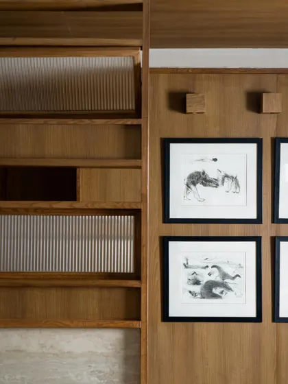 Details of the custom joinery and shelving at QBF Coffee. The design language is one of honest craftsmanship, with exposed brackets and a mix of wood and stone textures.