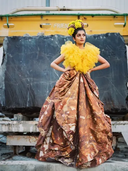 A creative composition from the marble factory shoot, using industrial machinery as a framing device. The contrast between the soft yellow tulle and the hard metal creates a compelling visual story.