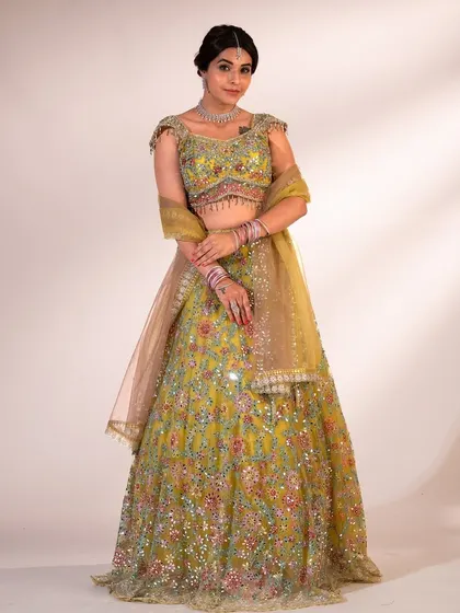 Another full-length shot of the lime green lehenga. The color is so fresh and the embroidery is just stunning, making it a perfect choice for a daytime wedding.
