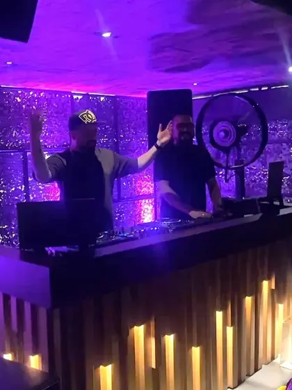 Waving to the crowd from the DJ booth at Kaze. It's a two-way energy exchange.