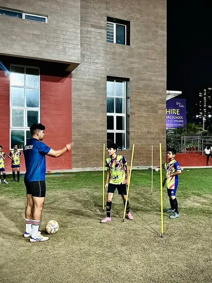 A coach demonstrating a drill to our U13 Elite Squad. Our licensed coaches provide hands-on instruction to ensure every player masters the correct technique.