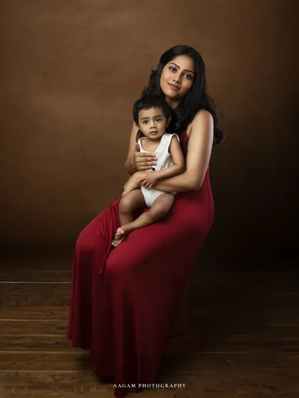 A seated fine art portrait of a mother and child. This classic pose, combined with the rich tones, results in an elegant and timeless family heirloom.