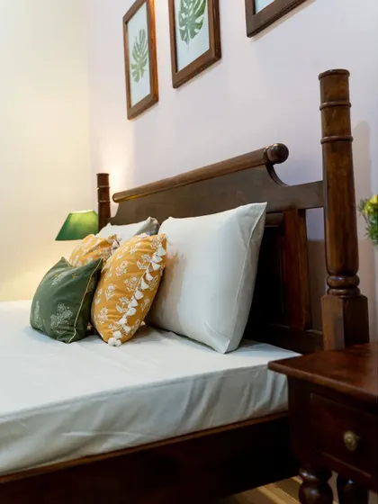 Another detail of the guest bed, highlighting the craftsmanship of the wooden posts and headboard.