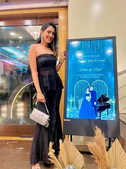 This digital welcome board for a Sangeet and Ring Ceremony looks so sleek. The design has a "Starry Night" theme with a deep blue background, piano illustration, and a glamorous caricature of the couple.