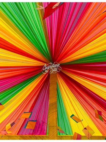 Looking up into the rainbow-draped canopy with kite details. This immersive ceiling treatment surrounded guests in color and added to the festive, celebratory feeling of the event.