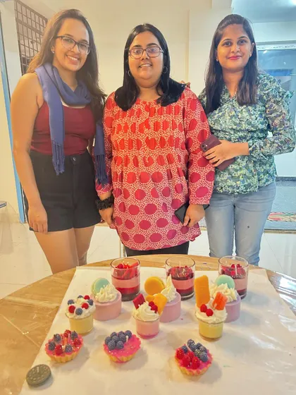A group of three friends showing off their impressive collection of handmade dessert candles.