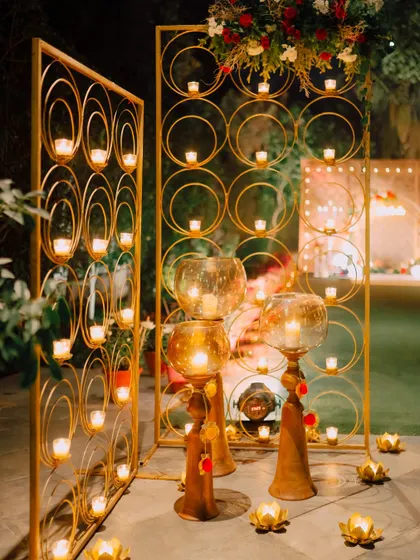 Golden candle stands with a geometric circular pattern, a modern and elegant decor element.