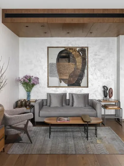 Another angle of the master bedroom's sitting area, highlighting the layering of textures and materials. The wood-paneled ceiling drop-down defines the space, while the mix of our custom furniture and collected accessories adds a personal, curated feel.
