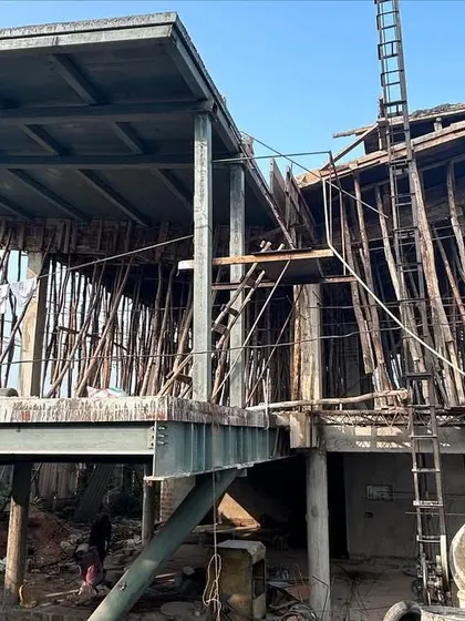 The Urbania Goa villa complex under construction. This behind-the-scenes shot reveals the steel and concrete skeleton that forms the dramatic, cantilevered shapes of the final architectural design.