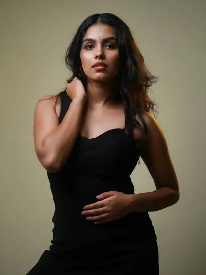 A similar pose with slightly different lighting. The subtle rim light separates the model from the background, adding depth to the portrait.