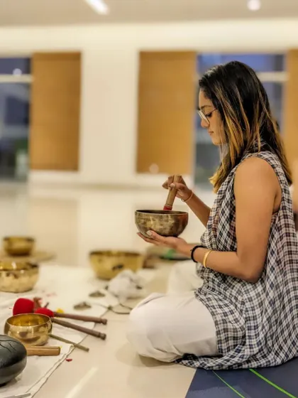 A profile shot of me playing a singing bowl, captured in a moment of deep concentration and connection with the instrument.
