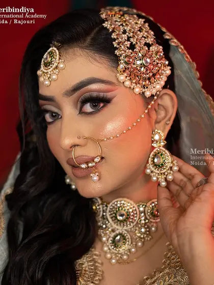 A close-up portrait that highlights the intricate details of the hair jewelry and the flawless makeup.