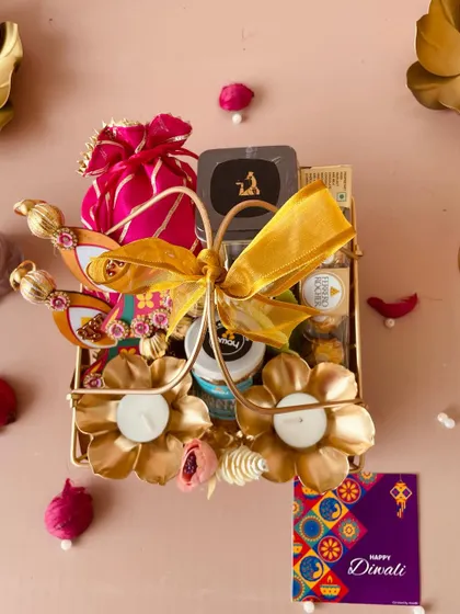 An overhead shot of the luxe metal basket, showcasing the golden bow and the collection of premium goodies packed inside.