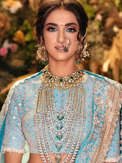 A stunning sky-blue bridal lehenga with intricate silver work. You'll learn how to work with cool-toned color palettes to create a unique and memorable bridal look.