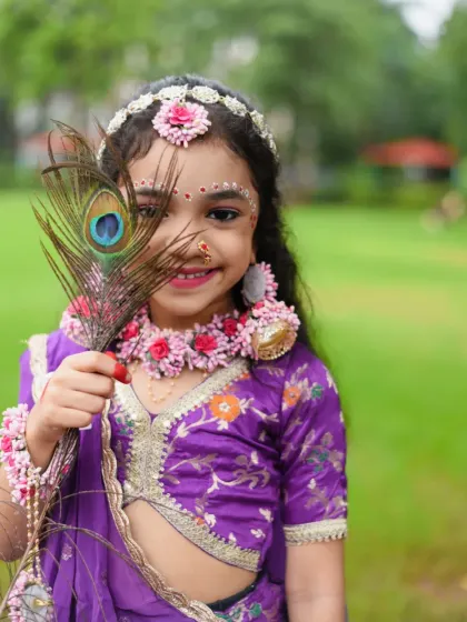 A cute and shy pose, with the peacock feather partially covering her face. This adds a touch of mystery and charm to the portrait.