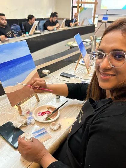 A participant looking up and smiling, enjoying the relaxed and creative atmosphere of the workshop.