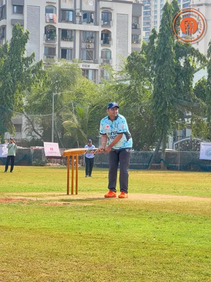 A batsman waits for the ball, bat raised, during a Parents Premier League match.