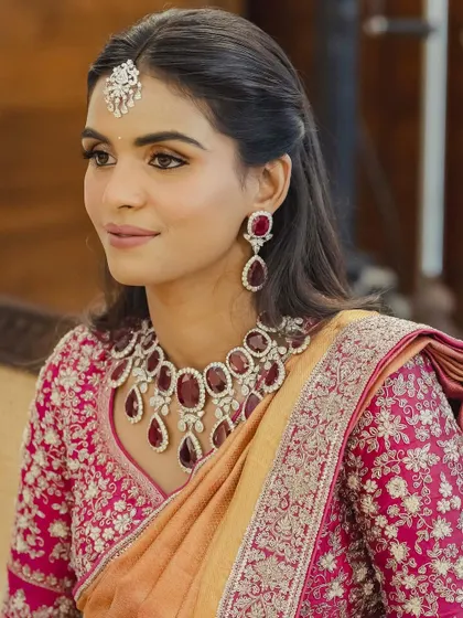 Another portrait of Manisha, showcasing her elegant half-up hairstyle and the intricate embroidery on her blouse.