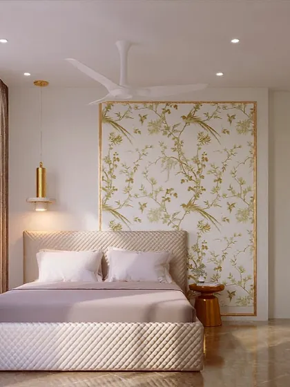 A classic white and gold bedroom design. The elegant wallpaper with a subtle chinoiserie pattern, paired with a quilted bed and modern gold lighting, creates a timeless and serene atmosphere.