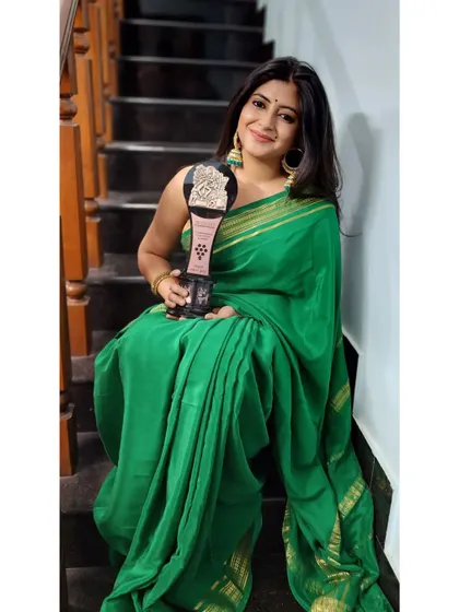 Another award moment, this time holding the trophy while sitting on the stairs, feeling so much gratitude. This one is for my family.